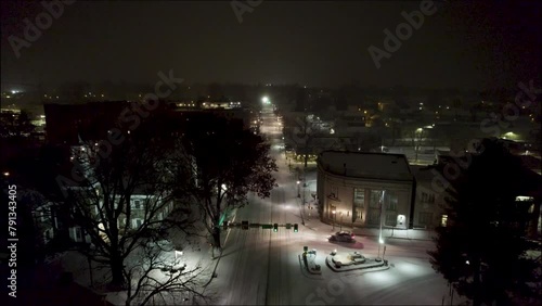 Aerial shot above a snowy road in downtown Lititz at night, going north. photo