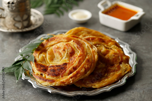 Roti Canai or Paratha with Chicken Curry photo