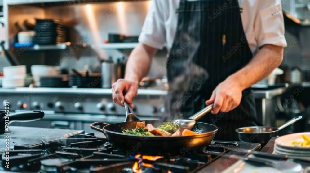side view of male chef cooking in the kitchen using a frying pan side view of male chef cooking in the kitchen using a frying pan