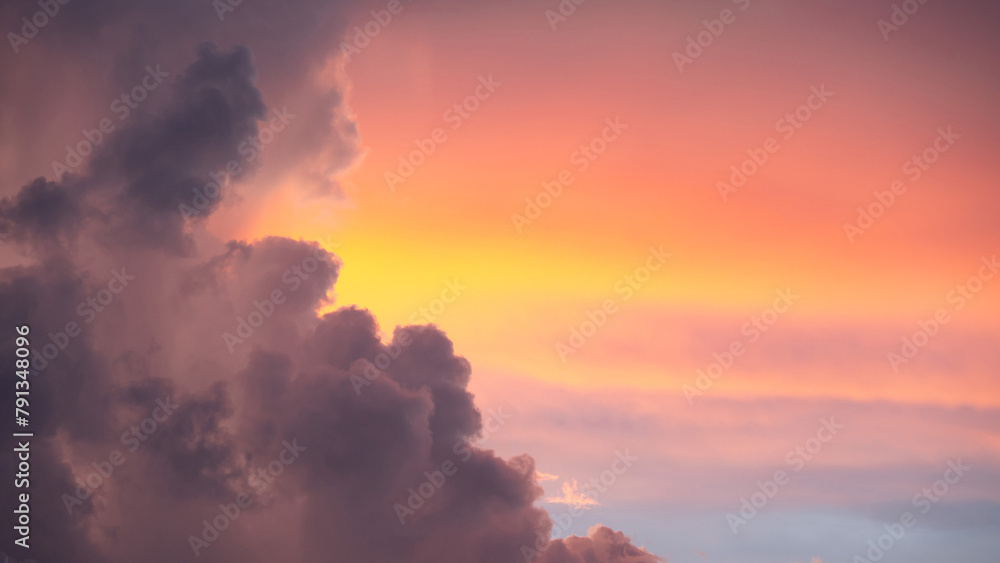 Sunset sky clouds at dusk with pink, yellow and purple sunlight after sundown or golden hour. Romantic twilight sky in the evening of summer season. Use for background or backdrop in nature concept