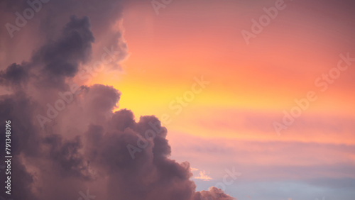 Sunset sky clouds at dusk with pink, yellow and purple sunlight after sundown or golden hour. Romantic twilight sky in the evening of summer season. Use for background or backdrop in nature concept
