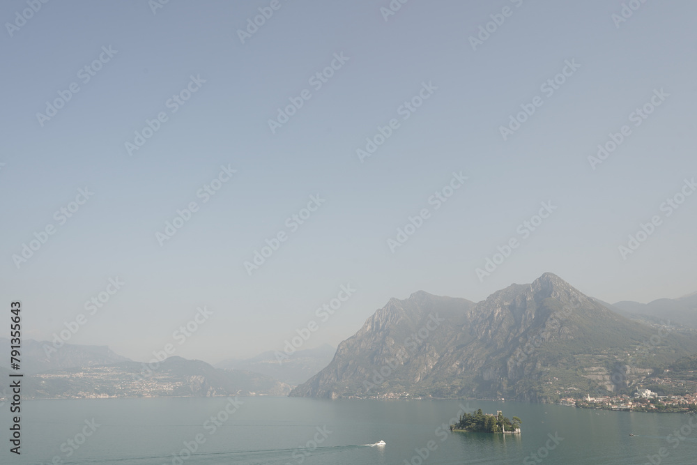 View of a glimpse of Lake Iseo and the small island of Loreto from Carzano area, Monte Isola . Italy