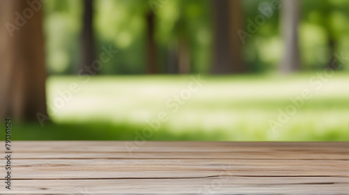 Wooden table on grass in a sunlit park with blurred nature background