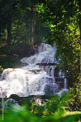 Pha Charoen Waterfall with shady surrounding trees in Phop Phra District, Tak Province, Thailand.