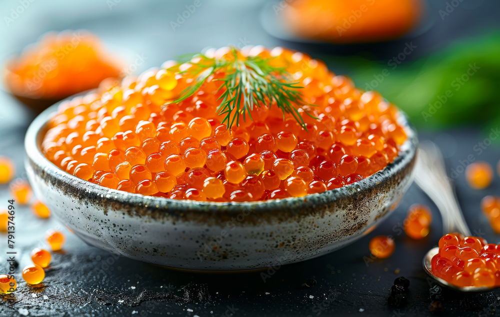 Red caviar in bowl on dark background. The photo shows caviar on the white plate on the table