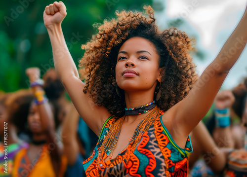 African American women at a rally in defense of their rights and freedom with their fists raised in the air. Day of Freedom, Emancipation, Equality and Unity