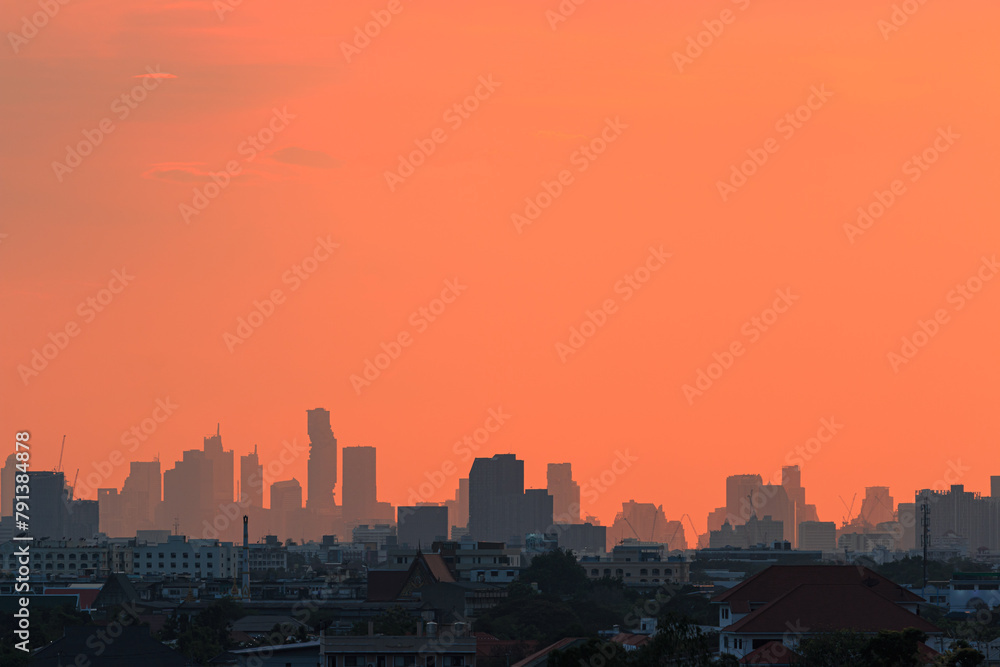 Background sky orange with cityscape of building silhouette,At twilight in Bangkok