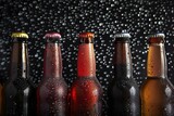 Bottles of beer on a dark background with drops of water