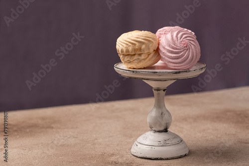 Vanilla-banana and berry raspberry marshmallows, Russian dessert, on a glass stand, open space
