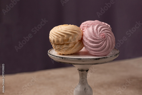 Vanilla-banana and berry raspberry marshmallows, Russian dessert, on a glass stand, open space