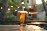 Glass of beer on wooden table in a pub with bokeh background