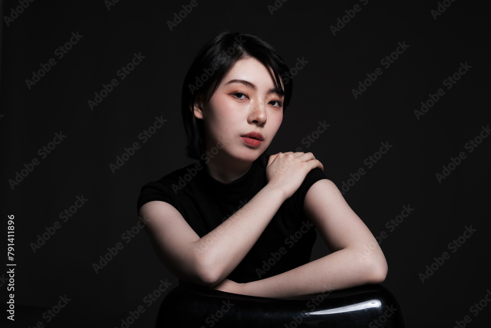 Beautiful woman posing against black background Beautiful woman posing against black background