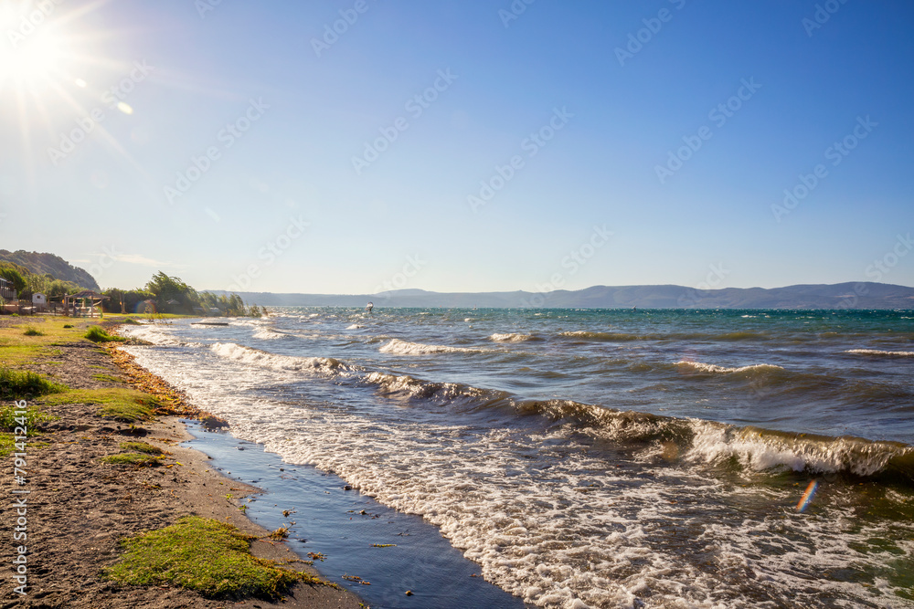 Italy, Lazio, Anguillara Sabazia, Sun shining over shore of Lake Bracciano Italy, Lazio, Anguillara Sabazia, Sun shining over shore of Lake Bracciano