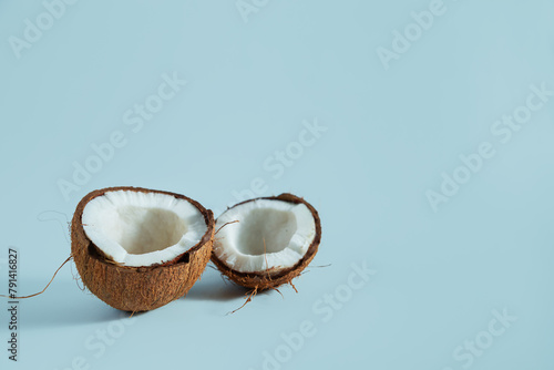Broken coconut pieces on a blue background.