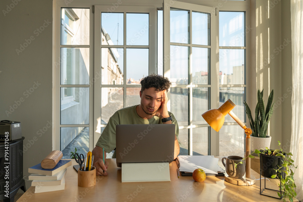 Young freelancer working on laptop at home Young freelancer working on laptop at home