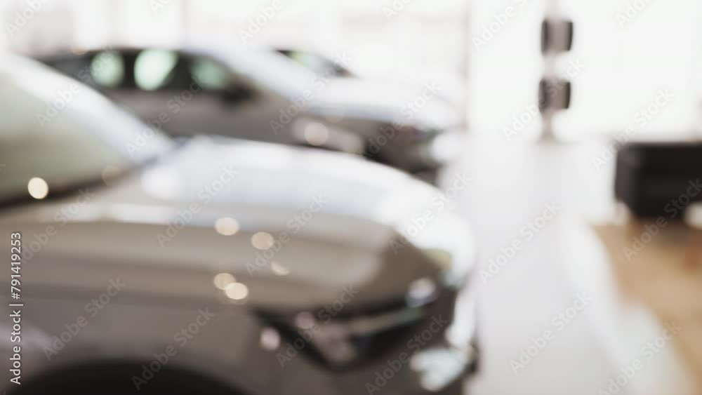 Cropped view of keys in hand of Caucasian male car dealer. Car salesman in suit holding keys, standing in front of row new modern vehicles for sale. Offer, discount concept. Cropped view of keys in hand of Caucasian male car dealer. Car salesman in suit holding keys, standing in front of row new modern vehicles for sale. Offer, discount concept.