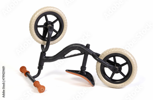 Modern black balace bike for a small child, isolated