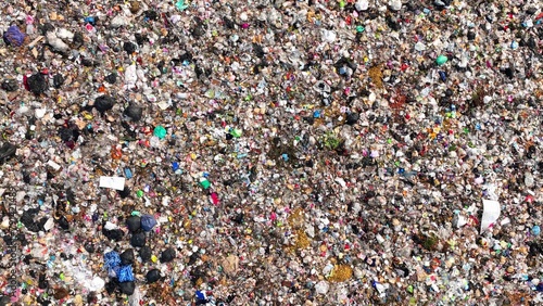 A dense collection of mixed waste, with various colors and shapes indicative of a wide range of discarded materials. Garbage background. Aerial view. 
