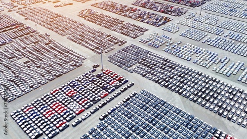 Fototapeta Naklejka Na Ścianę i Meble -  Captured from the sky, a panoramic view reveals a meticulously laid out parking lot, exemplifying strategic vehicle placement and the orchestration of mobility for smooth transit operations.
