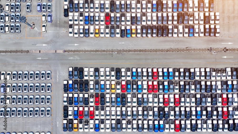 The aerial perspective unveils a meticulously arranged parking lot, a testament to automotive technological advancements, where each vehicle stands as a symbol of efficiency and progress.
The aerial perspective unveils a meticulously arranged parking lot, a testament to automotive technological advancements, where each vehicle stands as a symbol of efficiency and progress.