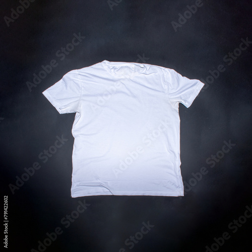 Obraz na plátně White t shirt on black background with place for text