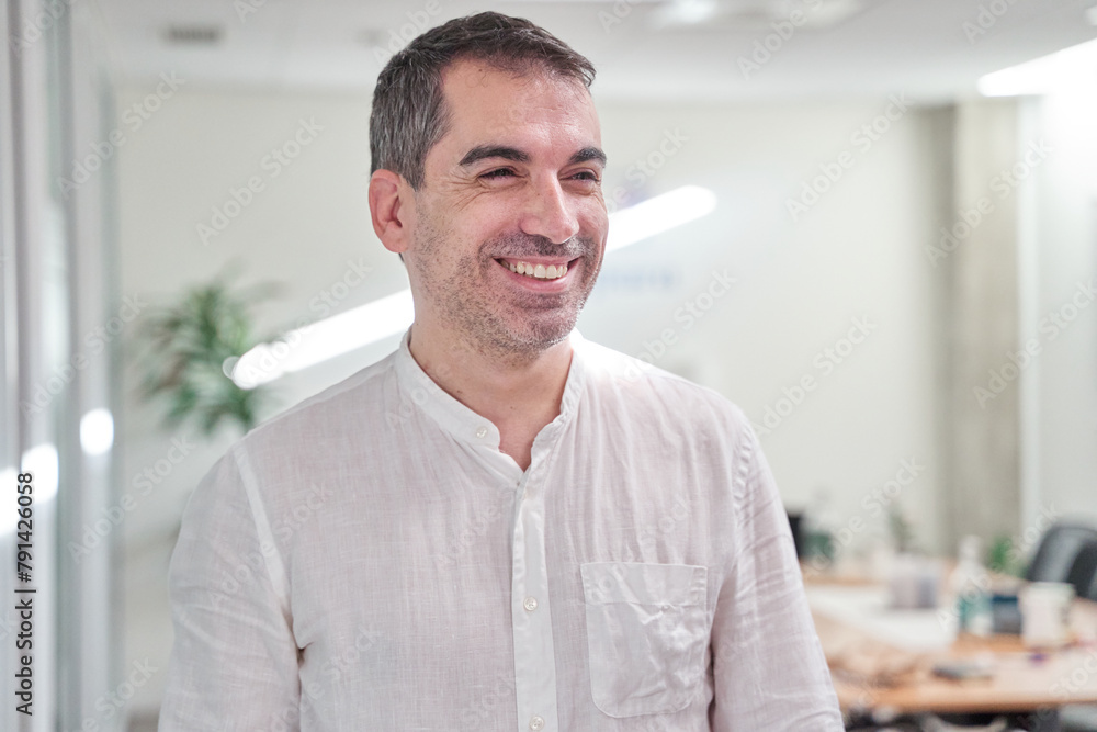 portrait of a smiling businessman in a modern office portrait of a smiling businessman in a modern office