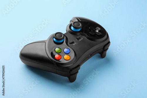 Wireless game controller on light blue background