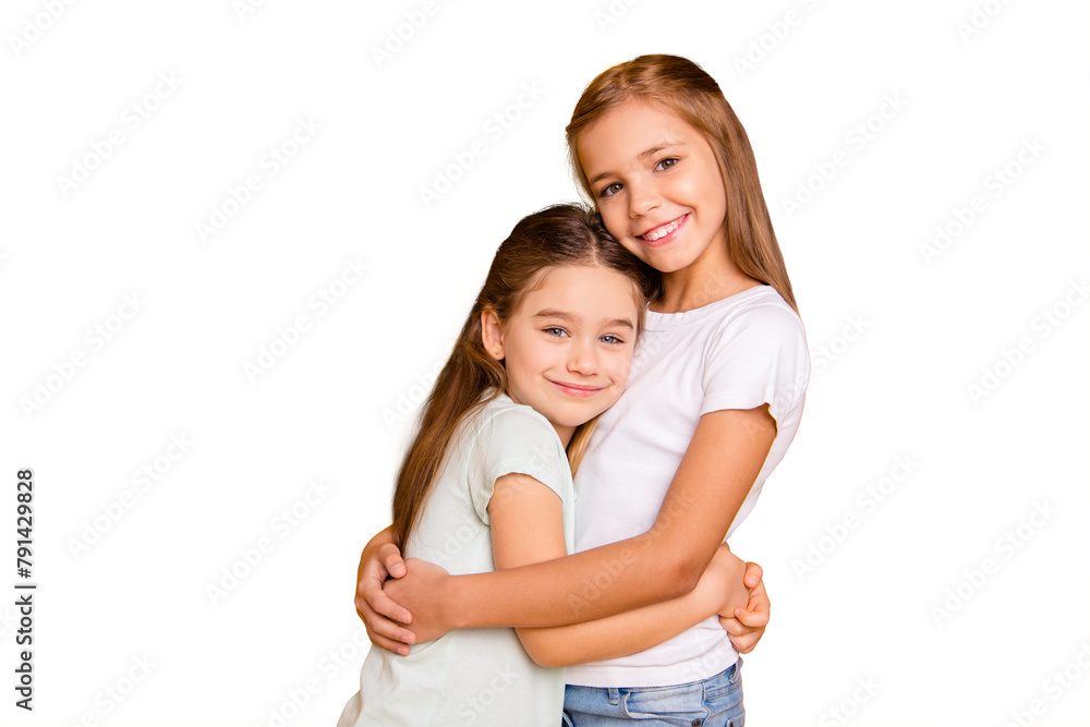 Portrait of two nice-looking cute adorable sweet attractive lovely pretty cheerful positive healthy straight-haired girls cuddling isolated over bright vivid shine yellow background