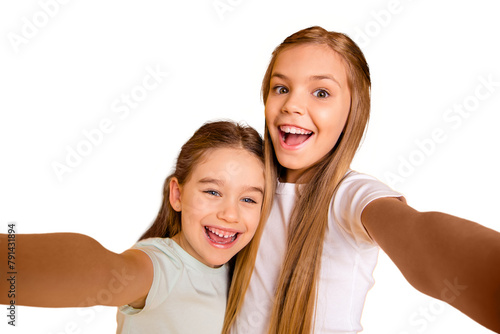 Self-portrait of nice-looking cool cute crazy attractive lovely winsome cheerful cheery positive emotional pre-teen girls having fun isolated over bright vivid shine yellow background