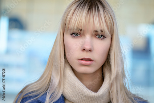 Portrait of young woman wearing blue coat. © Vladimir Arndt