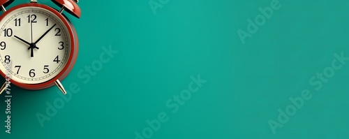 alarm clock on Teal background Minimalistic flat lay,with copy space for photo text or product, blank empty copyspace banner about time management and selfamplement concept. 