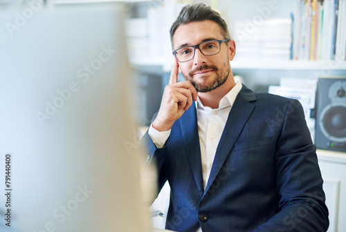 Portrait, confidence and business man in office on computer for career or job in Australia. Face, professional and consultant in glasses, entrepreneur and corporate employee in suit at workplace