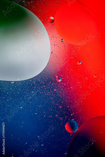 Oil floating on water with coloured background.