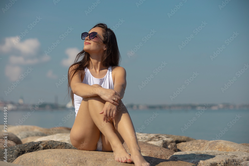 young beautiful woman in a white swimsuit young beautiful woman in a white swimsuit