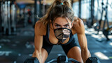 Young fit woman with n96 face mask  doing biceps exersice at the gym with kettlebells. Fitness strength workout under coronavirus health crisis.