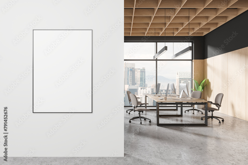 Fototapeta premium A modern office interior with a blank poster on the wall, wood elements, and city view through large windows. 3D Rendering
