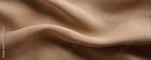 Brown linen fabric with abstract wavy pattern. Background and texture for design, banner, poster or packaging textile product. Closeup. with copy space for photo text or product, blank empty copyspace