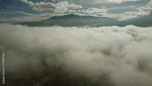 Sunny morning with a view of Pasochoa volcano. Dense mists and clouds create a magical atmosphere of natural beauty. Pichincha province, Ecuador
