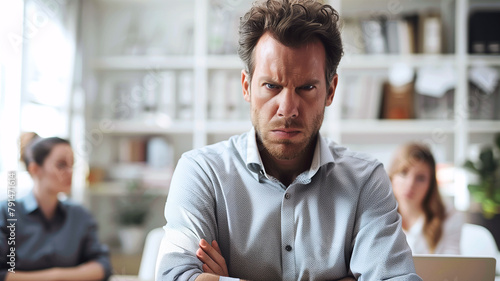 Portrait of businessman look serious and angry in office with coworker on background