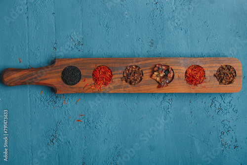 Different spicy variations into wooden rack in addition to food, make it more tasty. Indian and Turkish seasonings