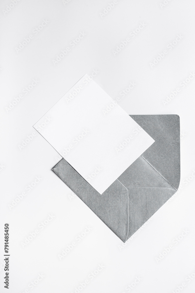 Blank sheet of paper on an envelope for letters. Space for text, top view Blank sheet of paper on an envelope for letters. Space for text, top view