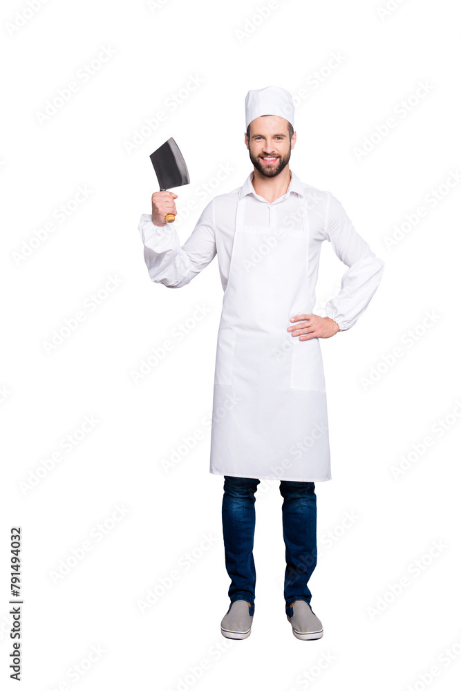 Full size fullbody portrait of  positive cheerful butcher in beret having cleaver in arm holding hand on waist, looking at camera, isolated on grey background