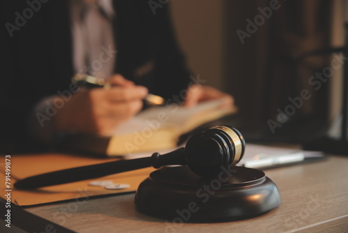 Business and lawyers discussing contract papers with brass scale on desk in office. Law, legal services, advice, justice and law concept picture with film grain effect