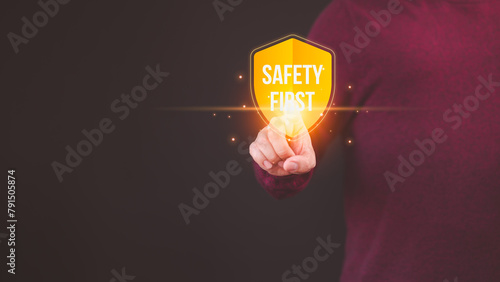 Person touching the safety banner symbol, highlighting a commitment to workplace safety, zero accidents, and fostering a culture of hazard awareness among workers. © ParinPIX