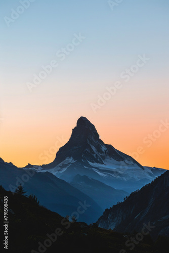 Silhouette of a single mountain peak against a clear sky during sunrise or sunset  with clean lines and negative space emphasizing the majesty of the natural landscape. 