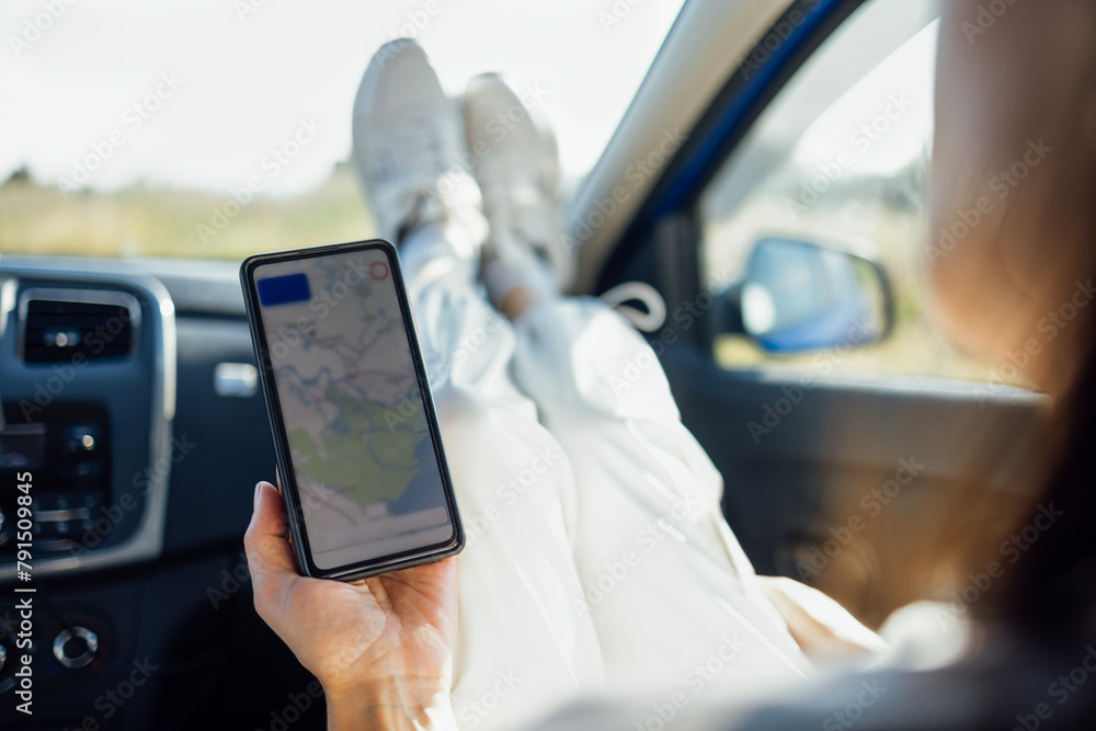 Close-up of a female face looking at the road on the navigator in the phone Close-up of a female face looking at the road on the navigator in the phone