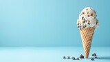 A melting ice cream cone with chocolate chips against a blue background