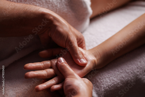 Close-up hands of professional masseuse working, massaging woman's hand in spa salon, therapeutic massage for relaxation. Healing, beauty, health, lifestyle, peace, relief, professional skills.