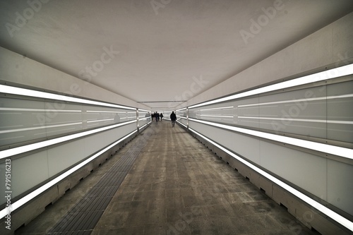 perspective view of a long illuminated underpass almost deserted