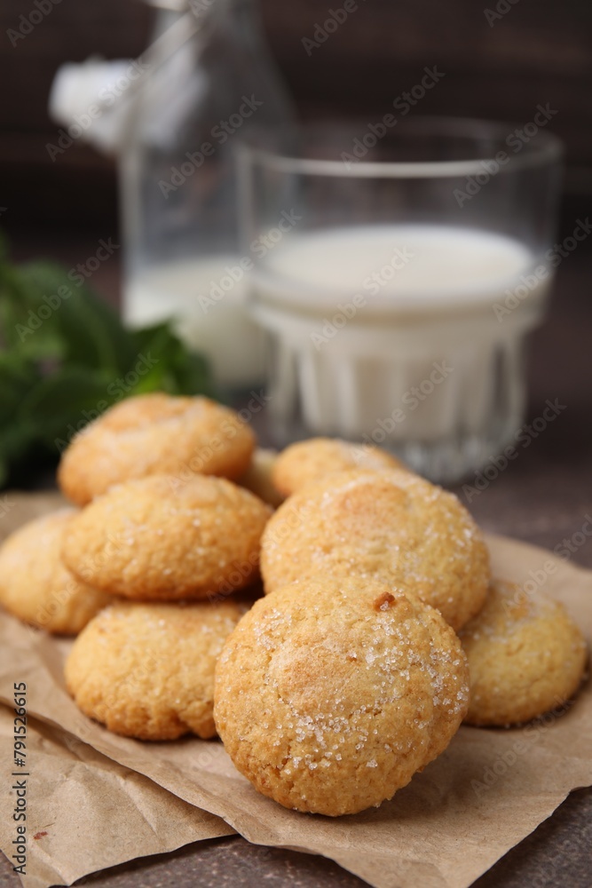 Tasty sweet sugar cookies and milk on brown table, closeup Tasty sweet sugar cookies and milk on brown table, closeup